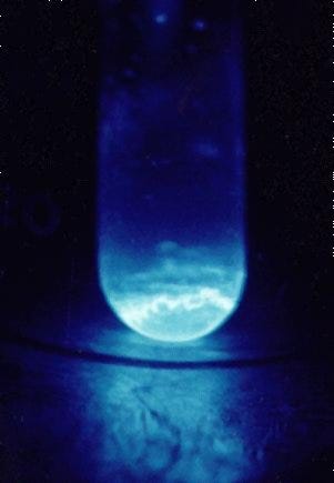 Einsteinium sample glowing from radiation decay.