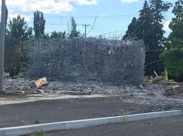 Demolition of a bank vault showcasing architectural change.