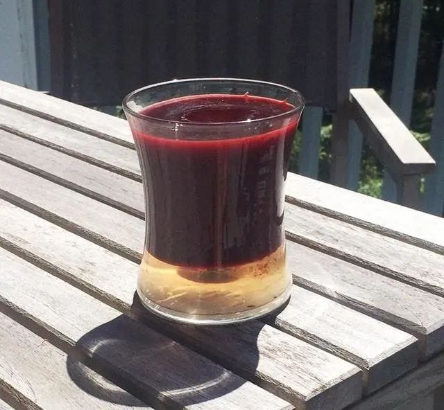 Candle in a cup demonstrating nature's elements.